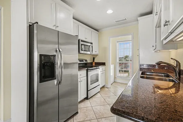 a kitchen with a refrigerator sink and stove
