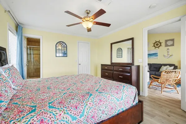 a bedroom with a bed and wooden floor