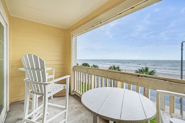 a view of a chair and table in the balcony