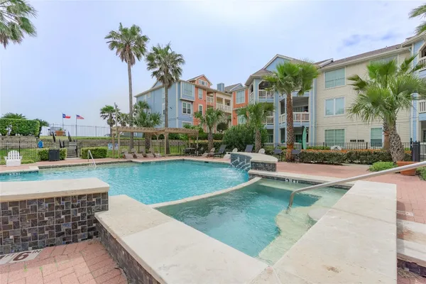 a swimming pool view with a outdoor seating