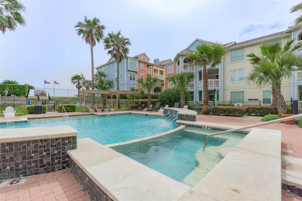 a swimming pool view with a outdoor seating