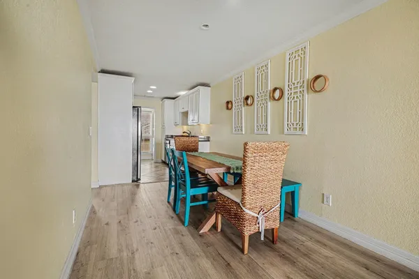 a view of a dining room with furniture and wooden floor