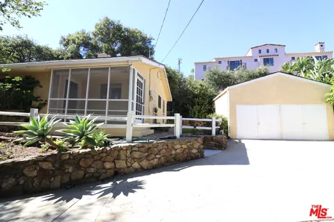 a view of a house with a flower garden