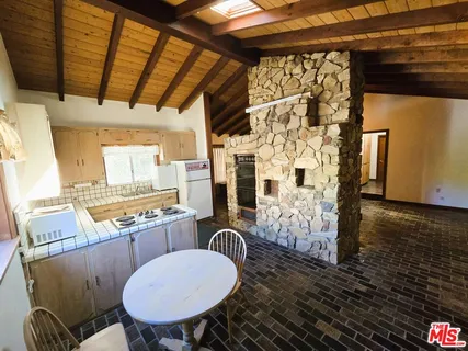 a view of backyard of house with outdoor seating