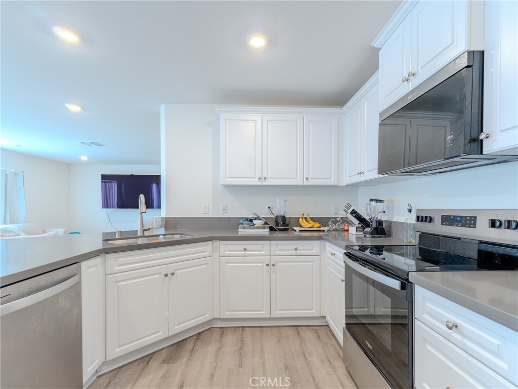 25602 Pne Rdg Road Homeland, CA 92548 - Photo 10 of 35 a kitchen with sink cabinets and stainless steel appliances