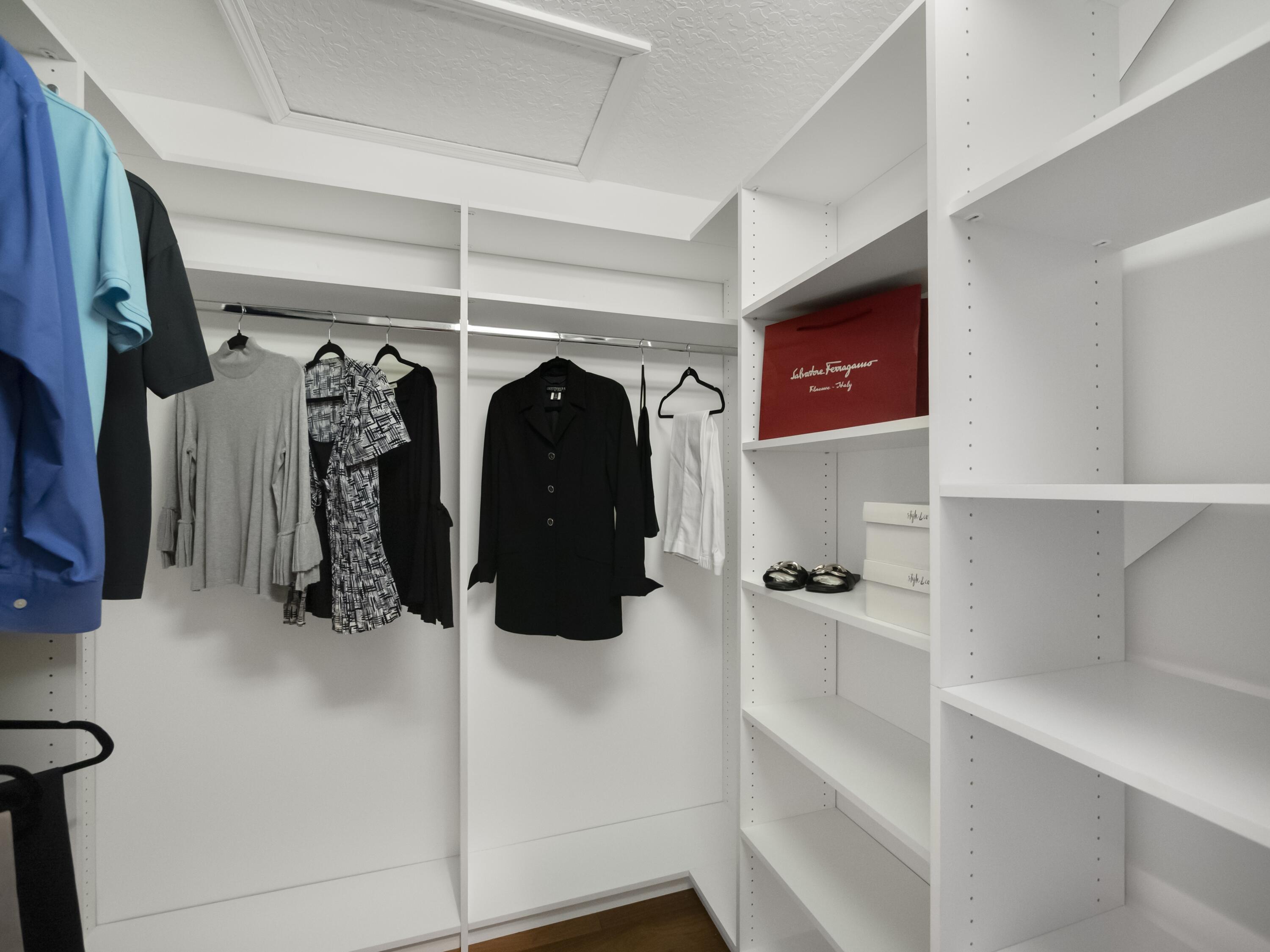 6279 Longleaf Pine Drive Jupiter, FL 33458 - Photo 11 of 33 a view of walk in closet with clothes and shoes