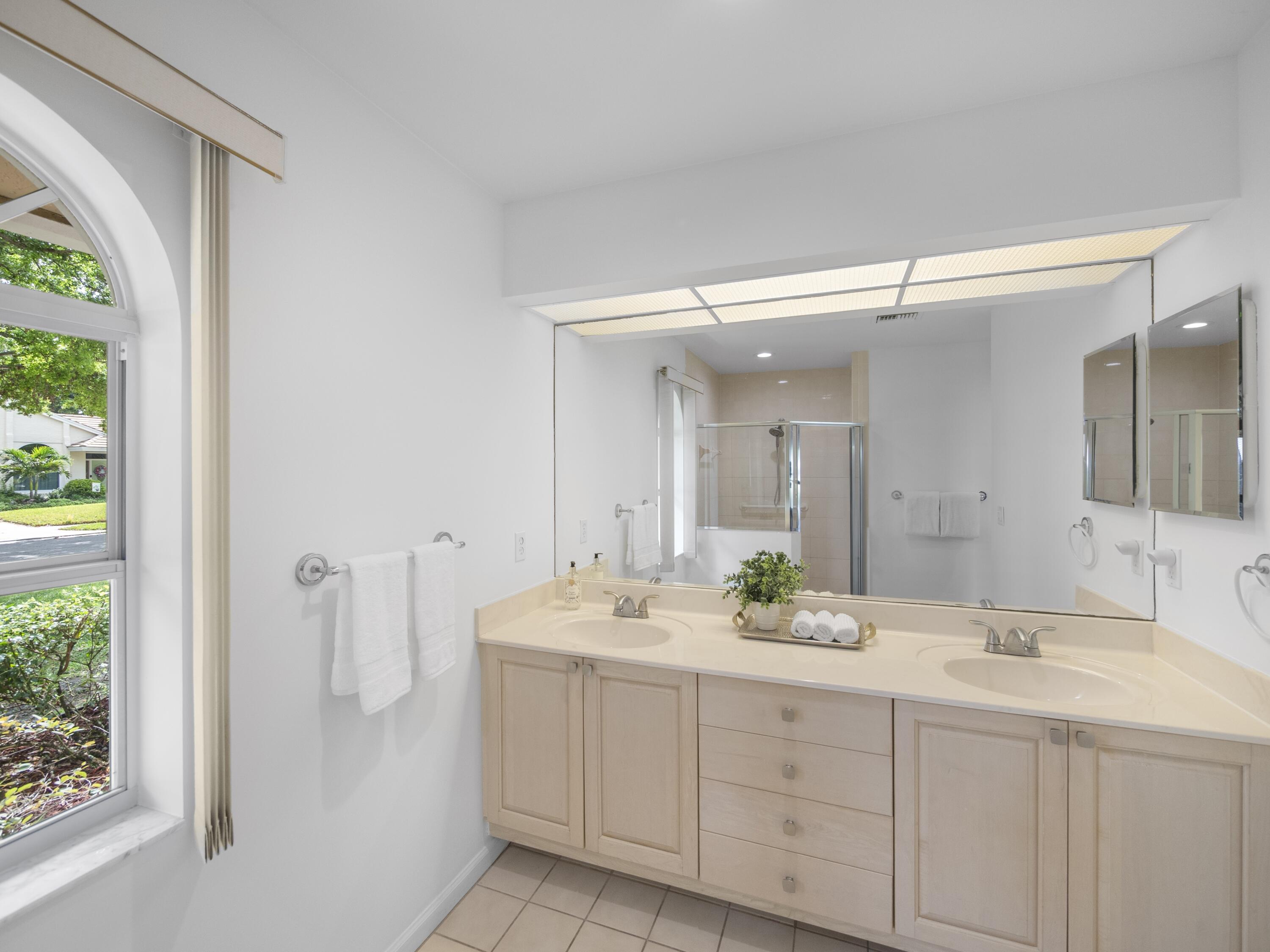 6279 Longleaf Pine Drive Jupiter, FL 33458 - Photo 12 of 33 a bathroom with a double vanity sink mirror and double