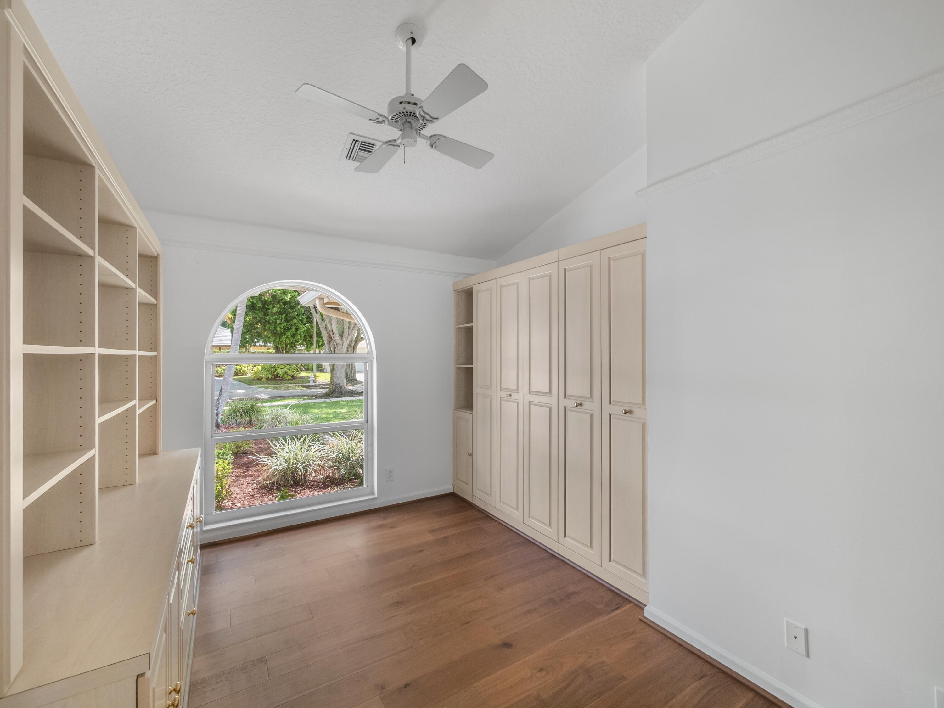 6279 Longleaf Pine Drive Jupiter, FL 33458 - Photo 13 of 33 an empty room with windows and ceiling fan
