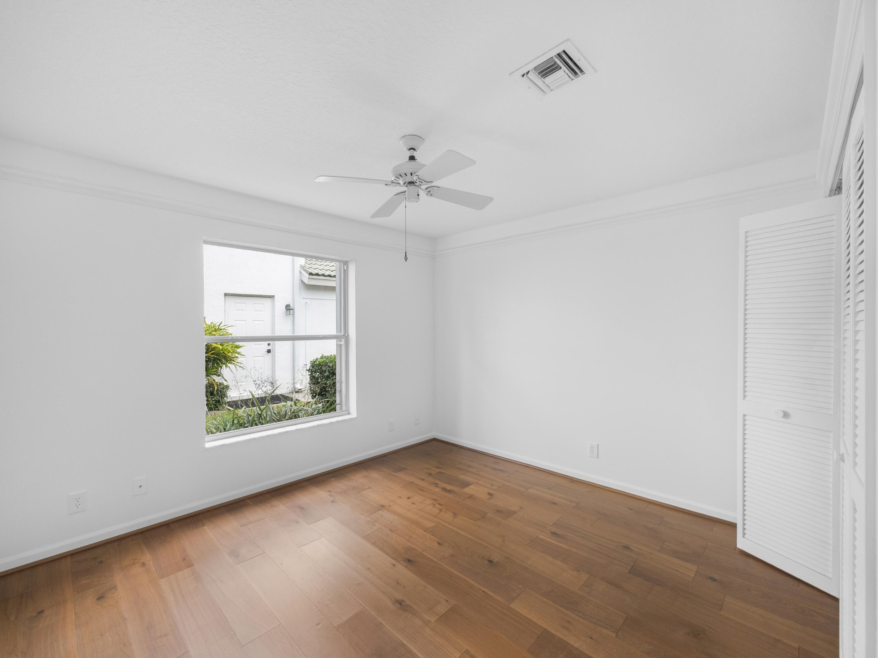 6279 Longleaf Pine Drive Jupiter, FL 33458 - Photo 14 of 33 wooden floor in an empty room with a window