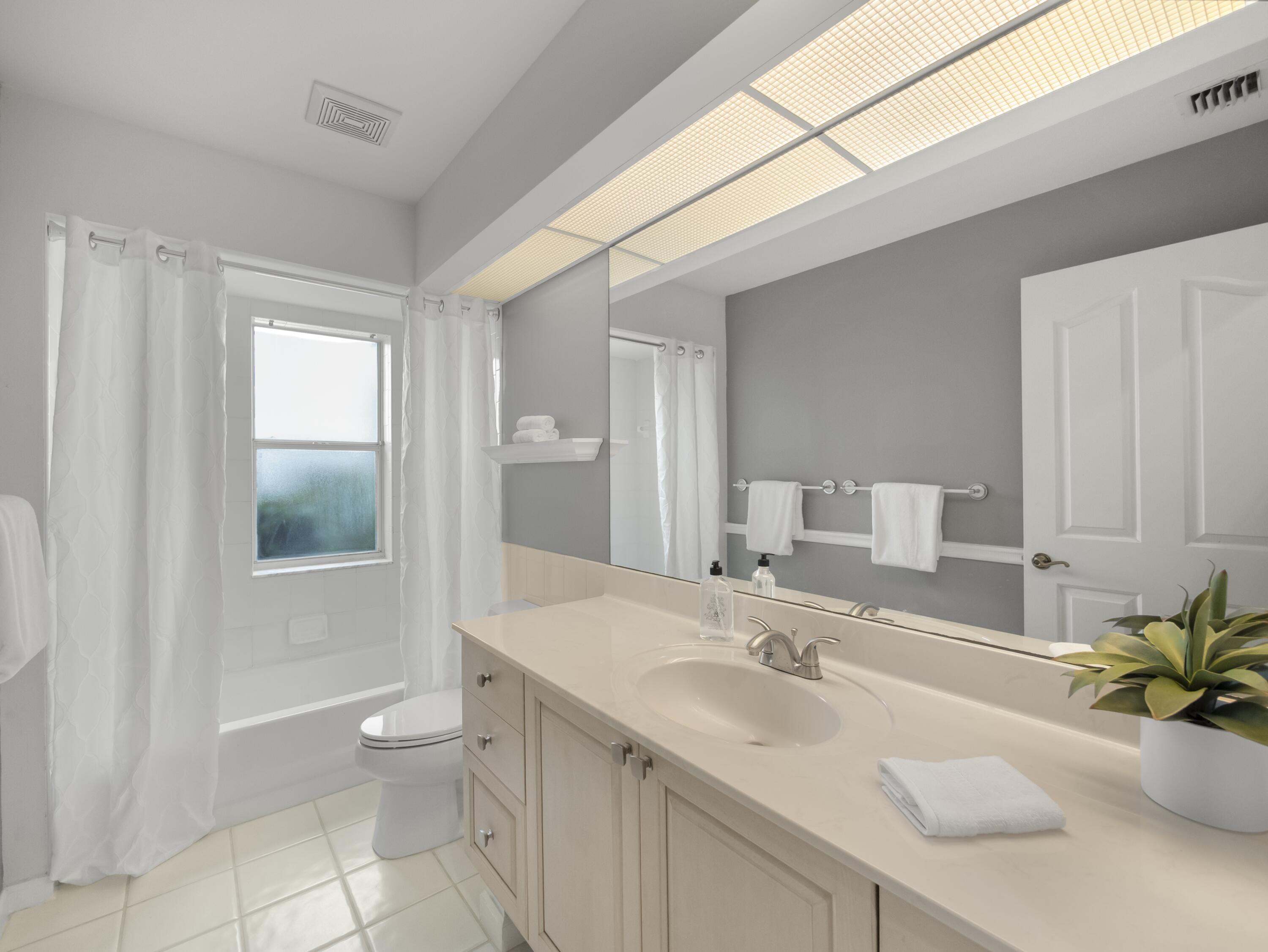 6279 Longleaf Pine Drive Jupiter, FL 33458 - Photo 15 of 33 a bathroom with a sink toilet and shower