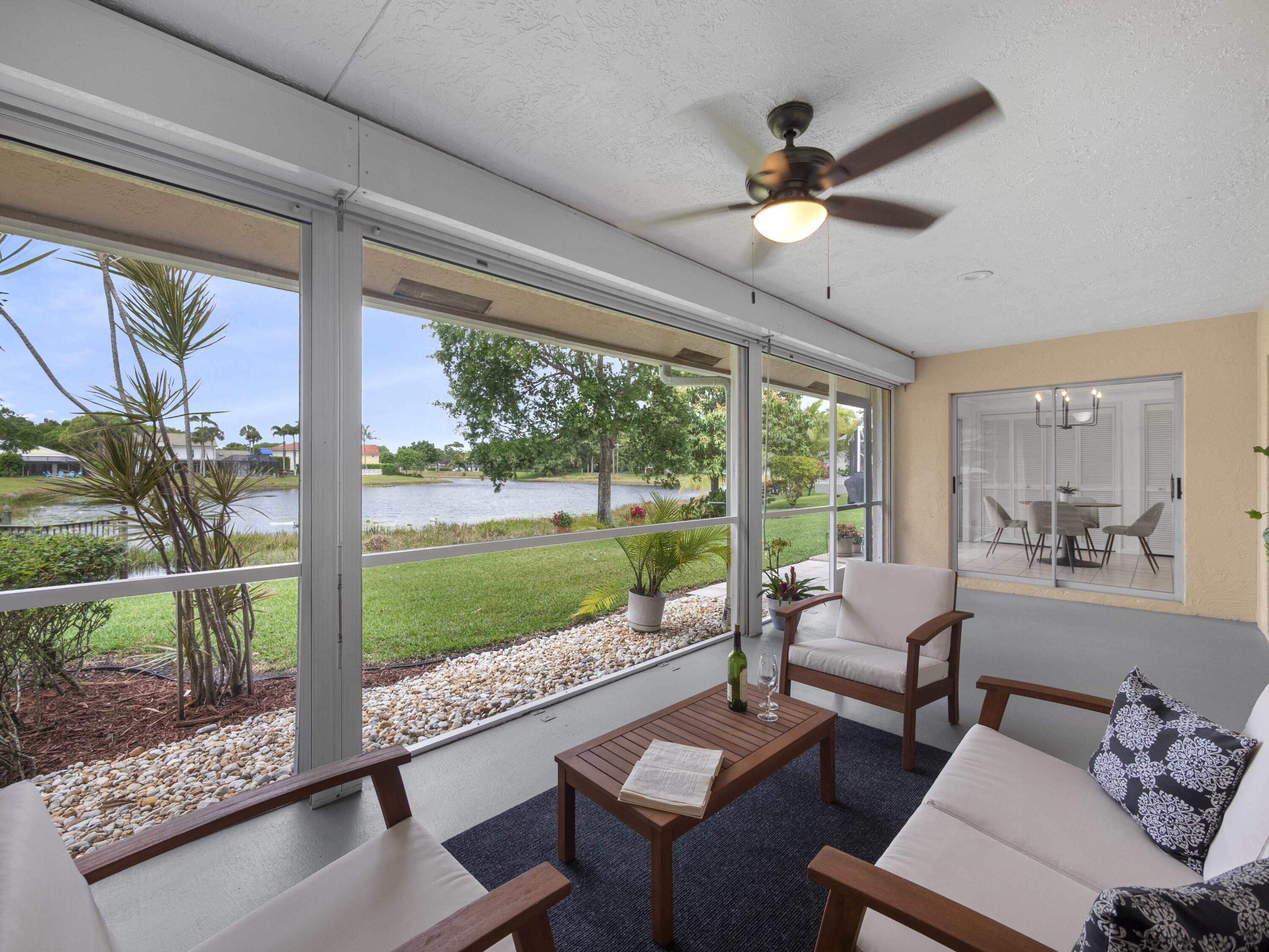 6279 Longleaf Pine Drive Jupiter, FL 33458 - Photo 19 of 33 a living room with couch and a floor to ceiling window