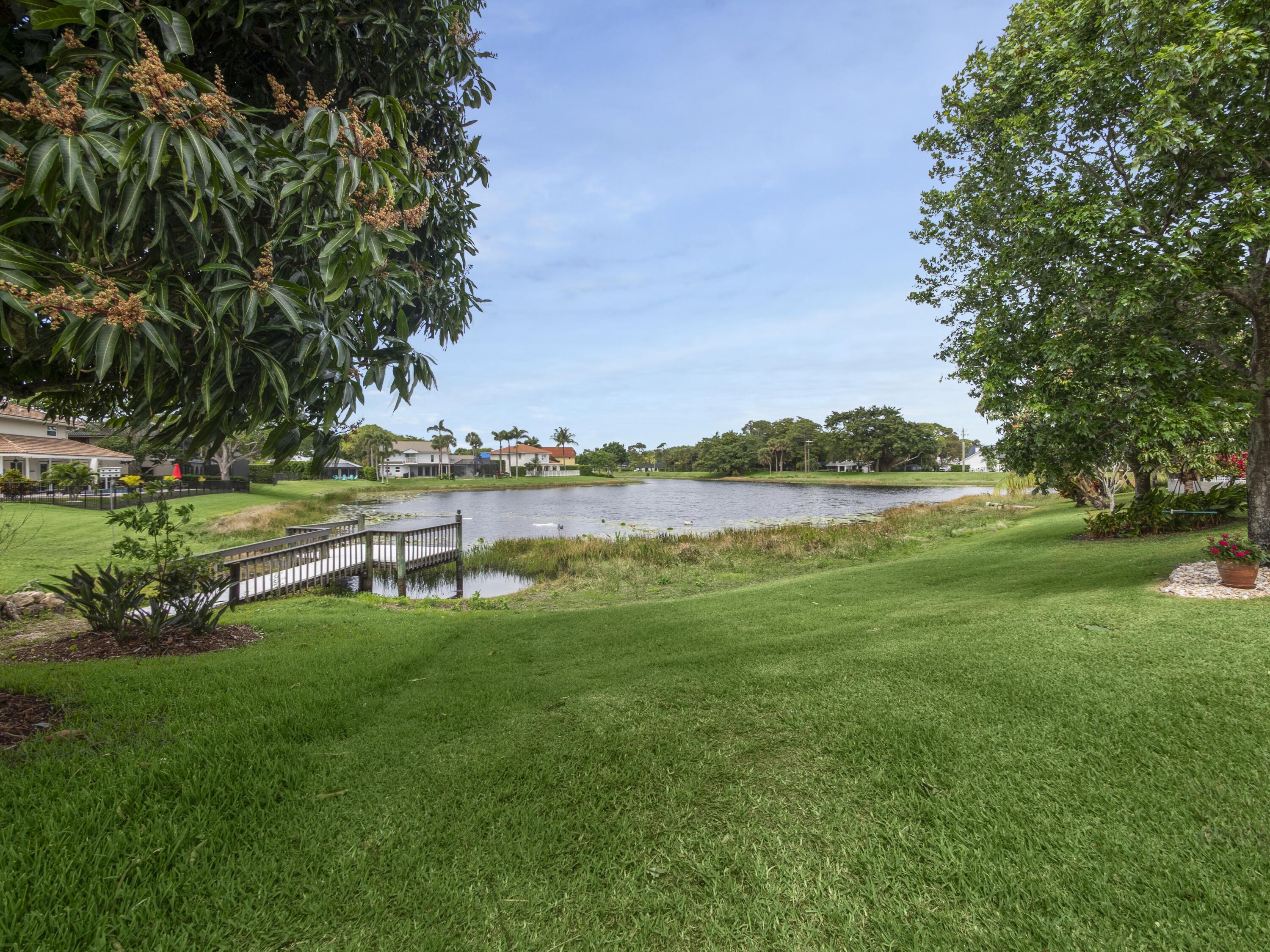 6279 Longleaf Pine Drive Jupiter, FL 33458 - Photo 20 of 33 a view of a lake with houses in the back