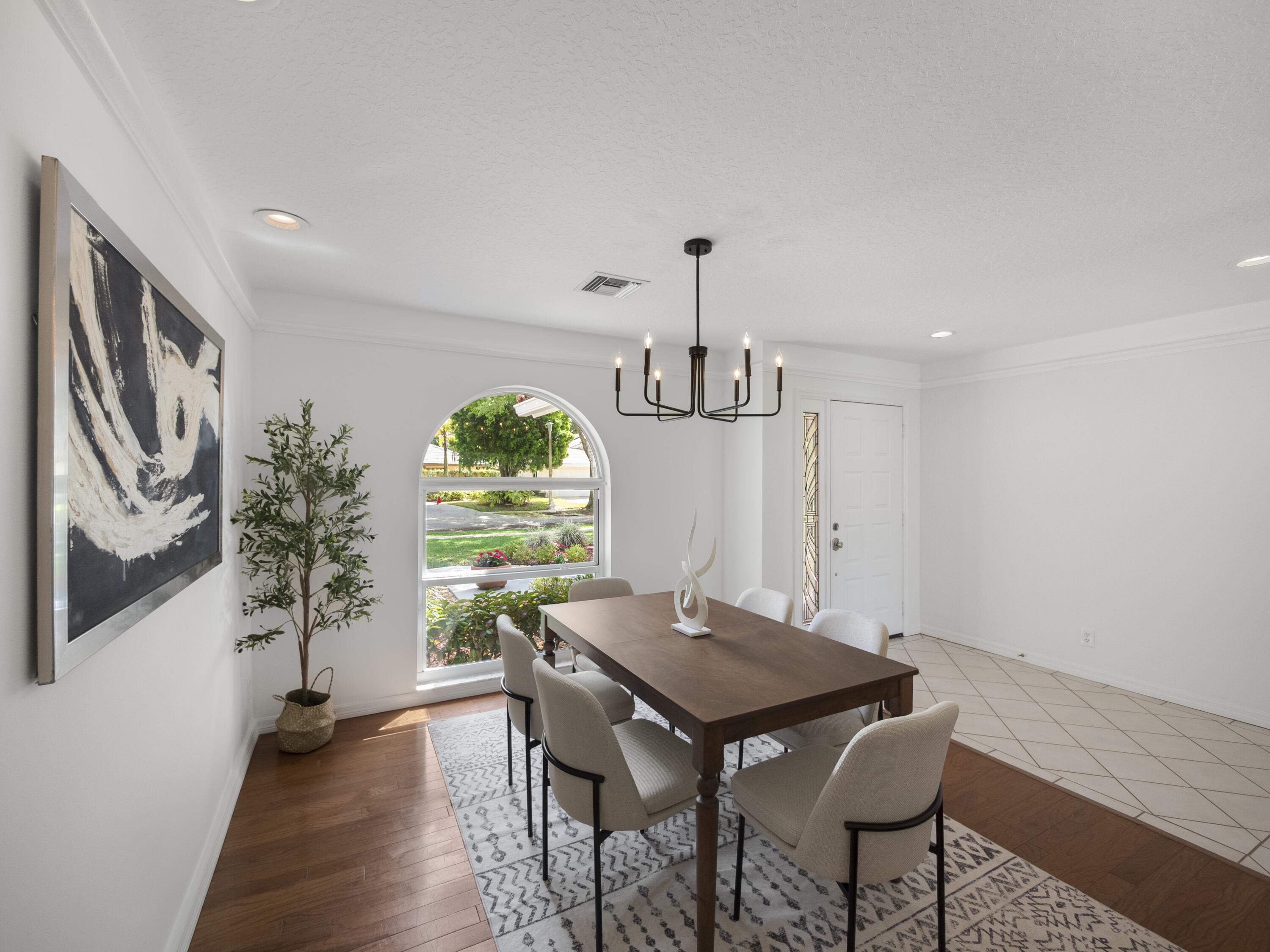 6279 Longleaf Pine Drive Jupiter, FL 33458 - Photo 4 of 33 a view of a dining room with furniture window and wooden floor