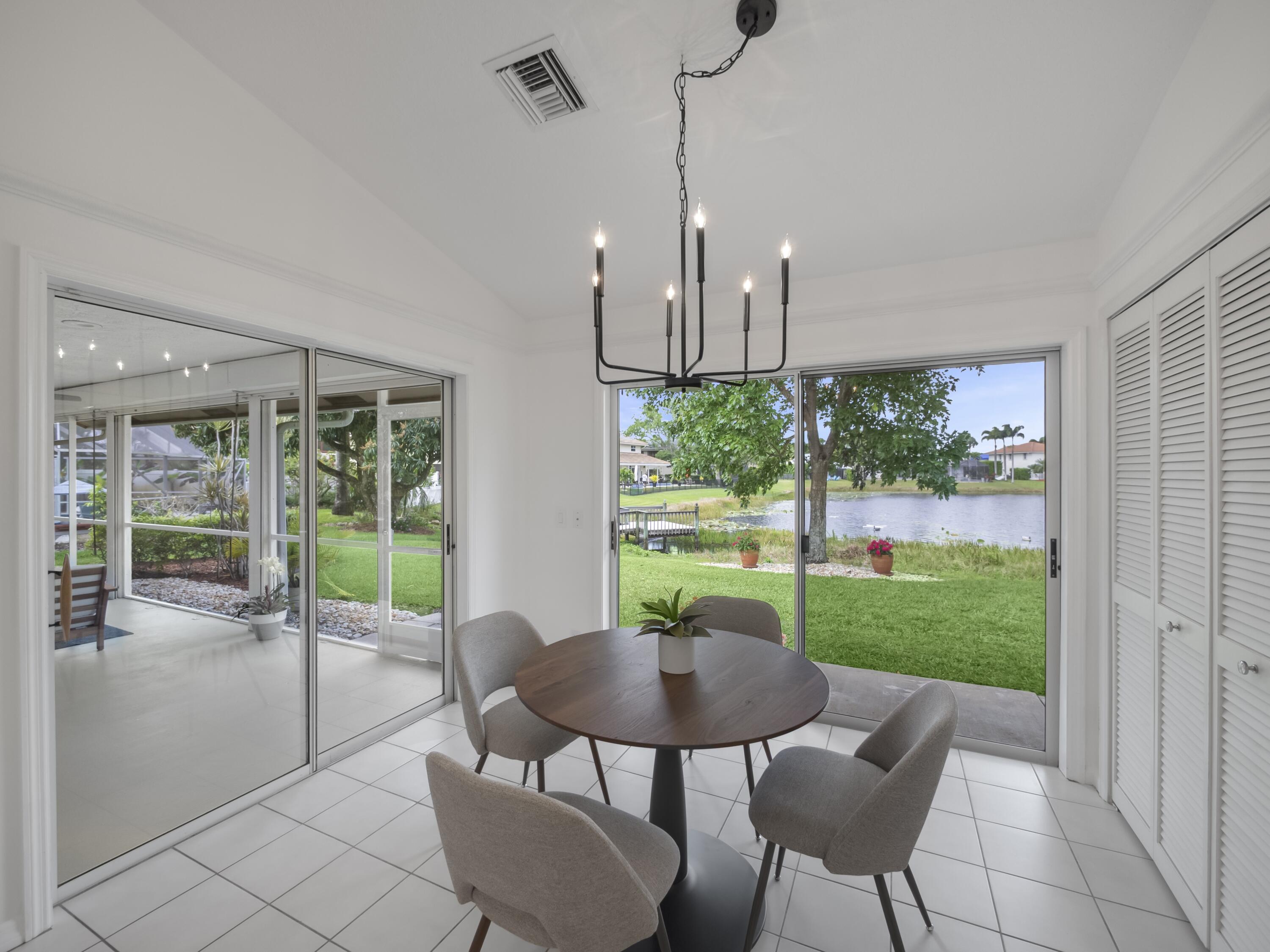 6279 Longleaf Pine Drive Jupiter, FL 33458 - Photo 8 of 33 a view of a dining room with furniture window and outside view