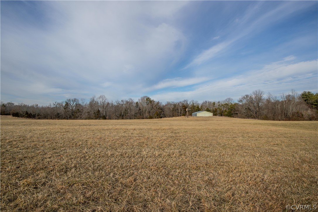 Lot 3 Carter Road Cumberland, VA 23040 - Photo 3 of 16 A large open field with the hangar in the backgrou