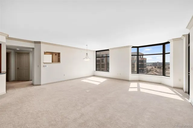 an empty room with windows and entrance