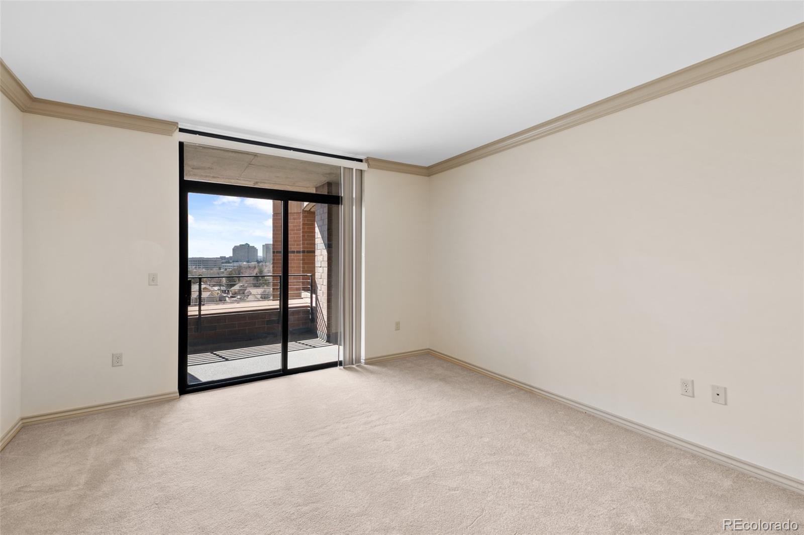 8100 East Union Avenue, Unit 814 Denver, CO 80237 - Photo 18 of 38 a view of an empty room with wooden floor and a window