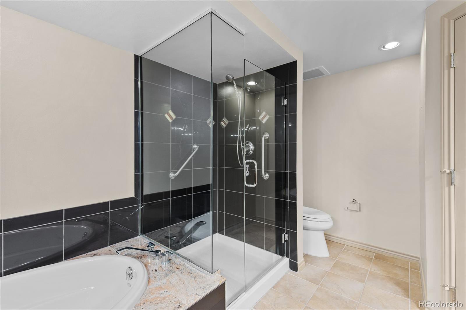 8100 East Union Avenue, Unit 814 Denver, CO 80237 - Photo 23 of 38 a bathroom with a sink a toilet and shower