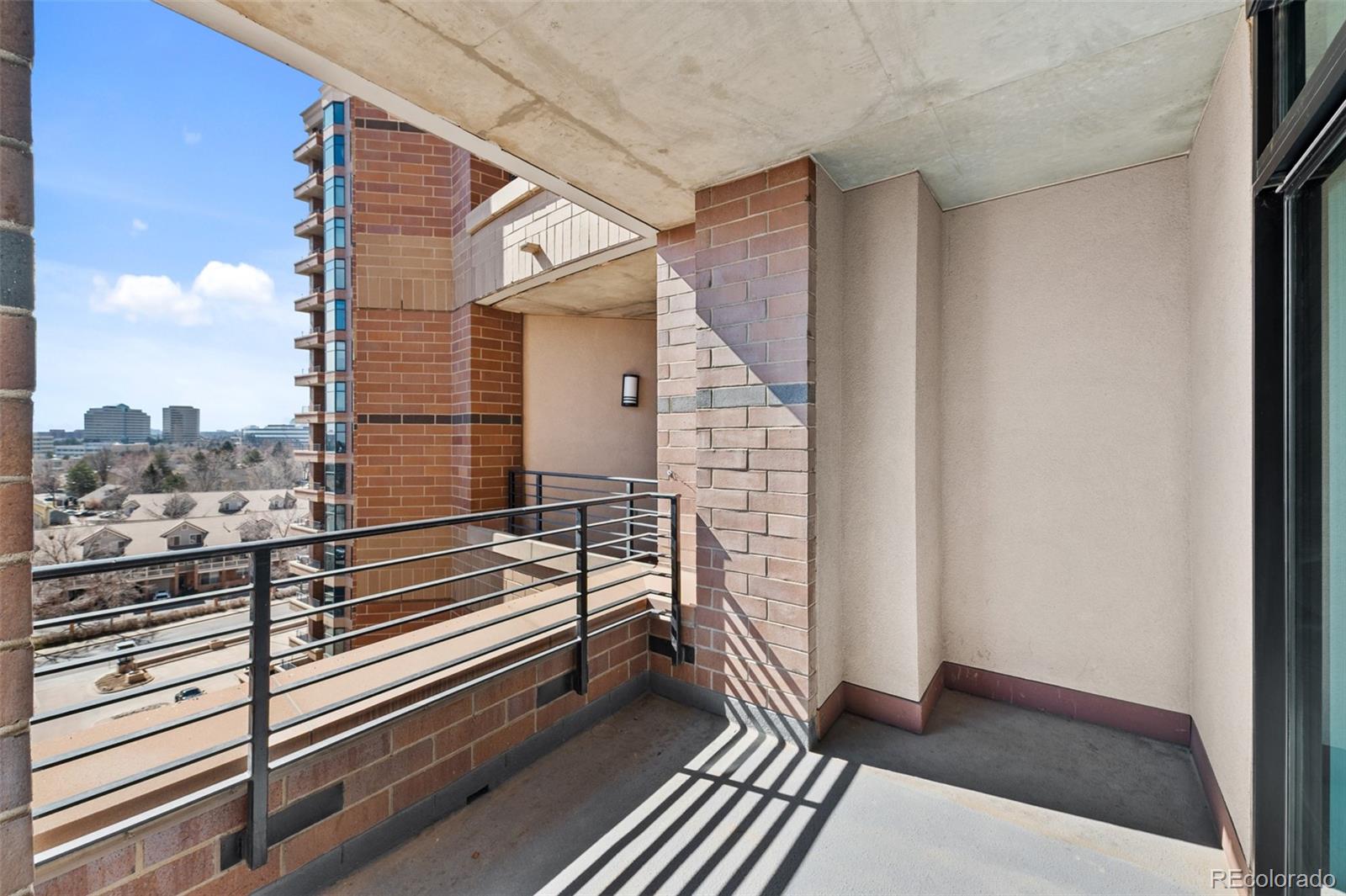 8100 East Union Avenue, Unit 814 Denver, CO 80237 - Photo 30 of 38 a view of a balcony with wooden floor and city view
