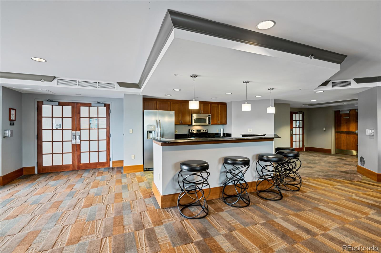 8100 East Union Avenue, Unit 814 Denver, CO 80237 - Photo 31 of 38 a view of a living room and kitchen with furniture wooden floor and windows