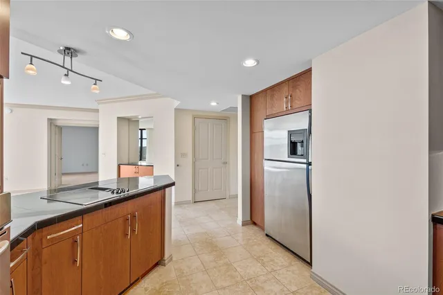 a kitchen with refrigerator cabinets and a sink
