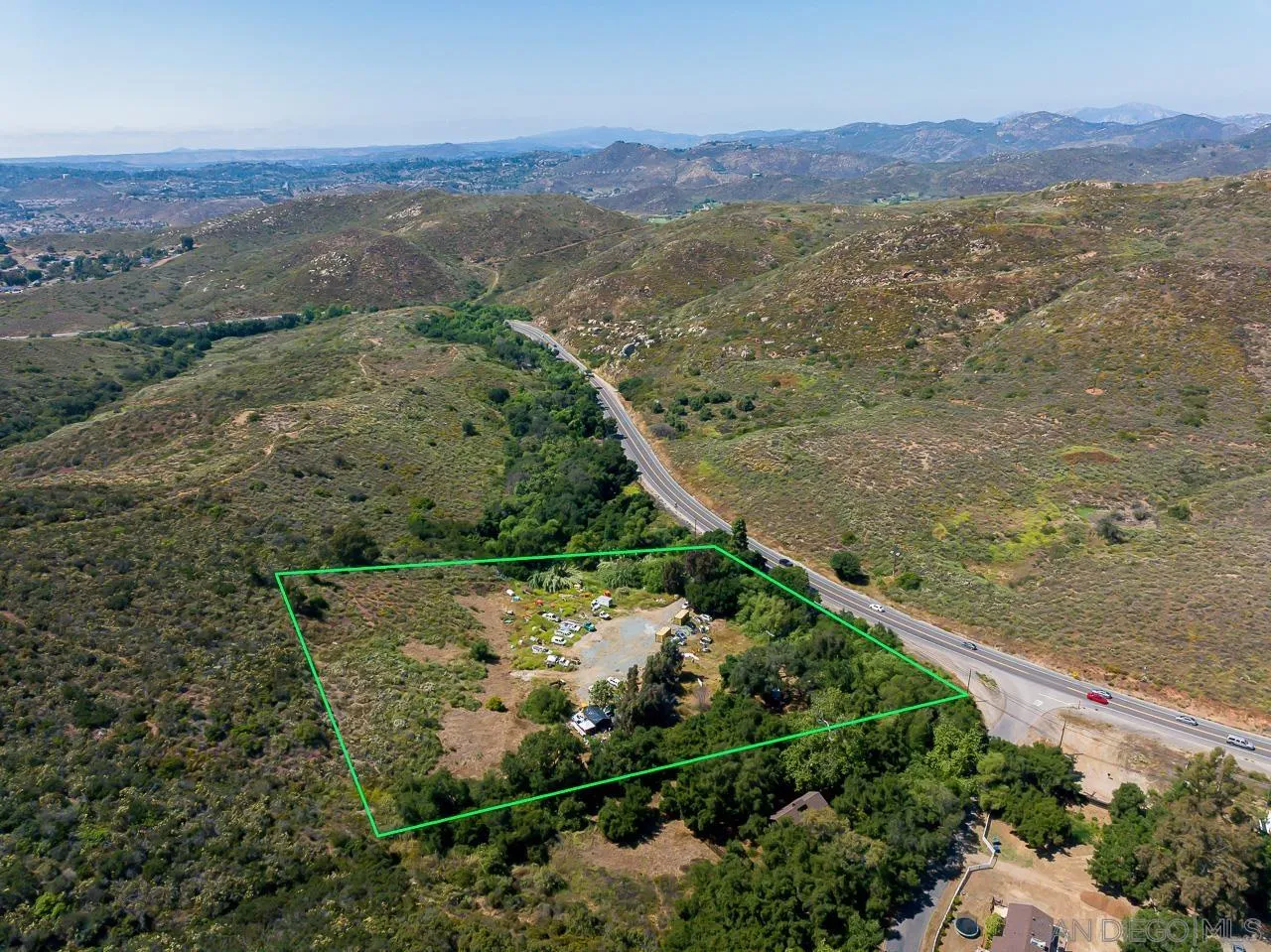 13455 Campo Road, Unit 5960314300 Jamul, CA 91935 - Photo 5 of 10 an aerial view of mountain with residential house and green space