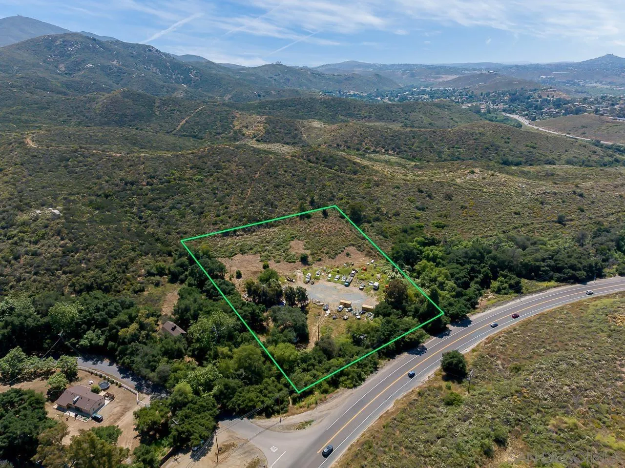 13455 Campo Road, Unit 5960314300 Jamul, CA 91935 - Photo 6 of 10 an aerial view of a house with a yard and mountain view in back