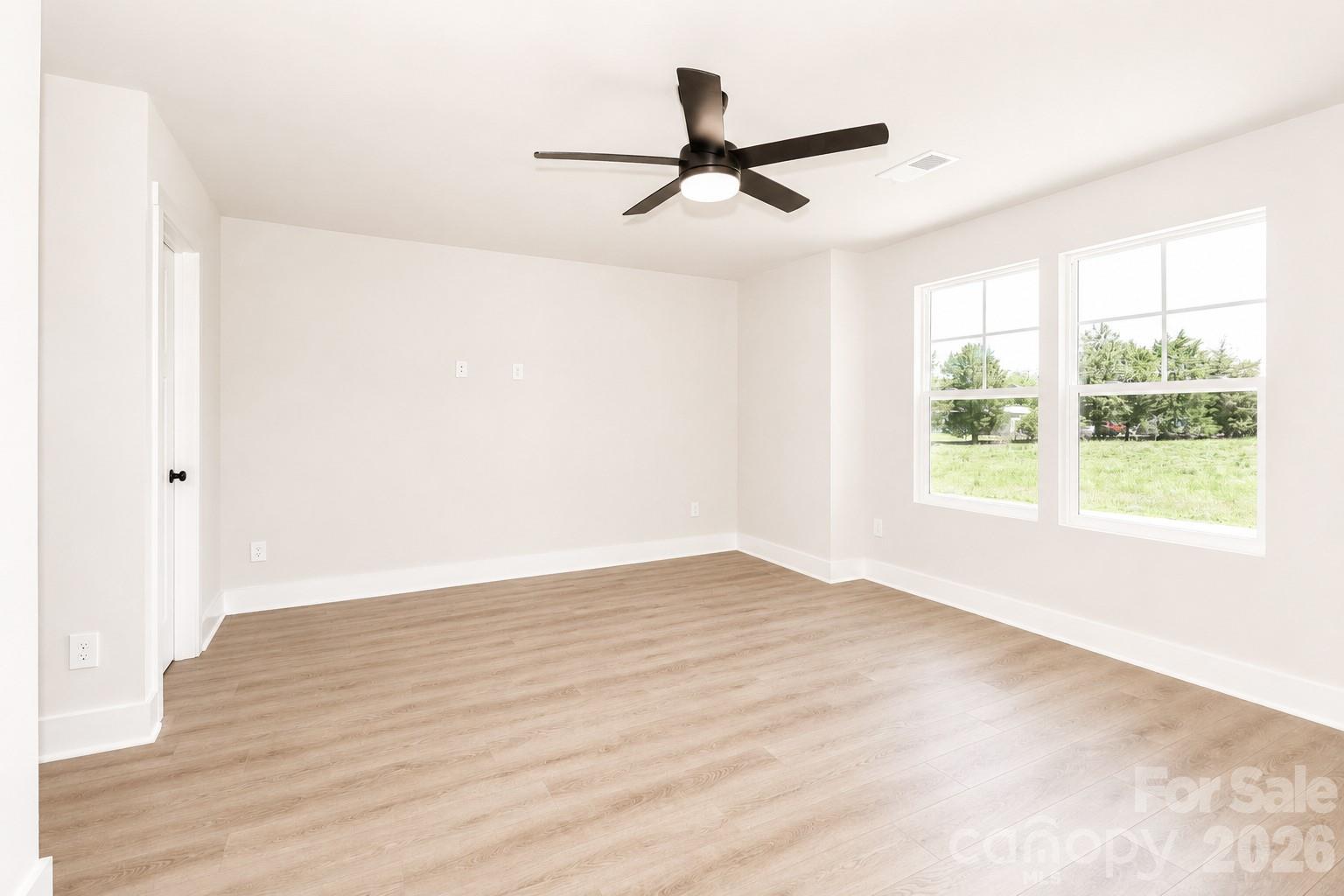 237 3rd Creek Road Stony Point, NC 28678 - Photo 16 of 29 a view of empty room with wooden floor and fan