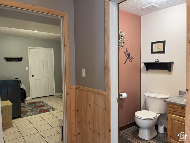 750 South Big Road Soda Springs, ID 83276 - Photo 26 of 40 Powder room featuring a single vanity with a stone-finish countertop, wood-finish flooring, and a white toilet