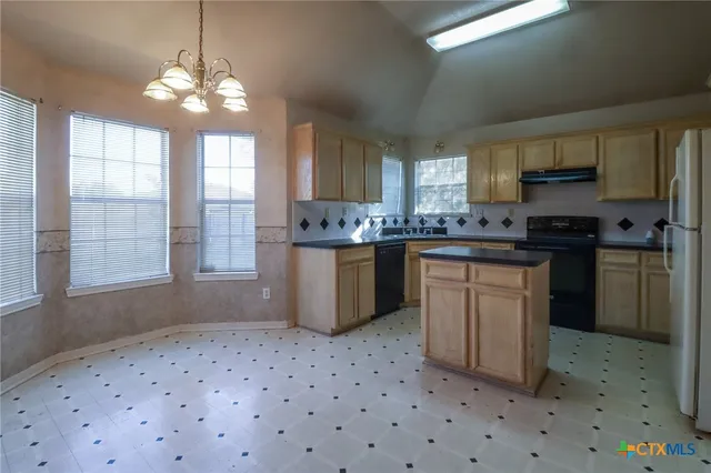 a kitchen with a sink stove and cabinets