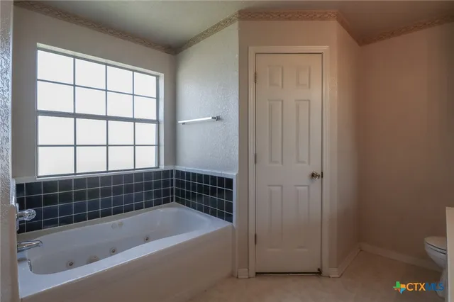 a bathroom with a bathtub and window