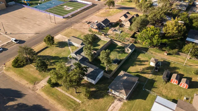 an aerial view of a house with a yard