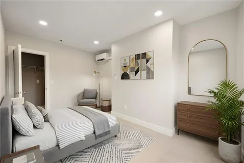a bedroom with bed and a potted plant