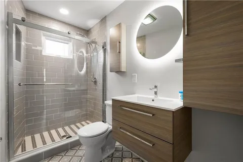 a bathroom with a sink toilet and a mirror