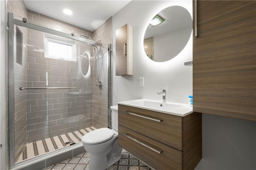 807 McCandless Avenue Pittsburgh, PA 15201 - Photo 14 of 24 a bathroom with a sink toilet and a mirror
