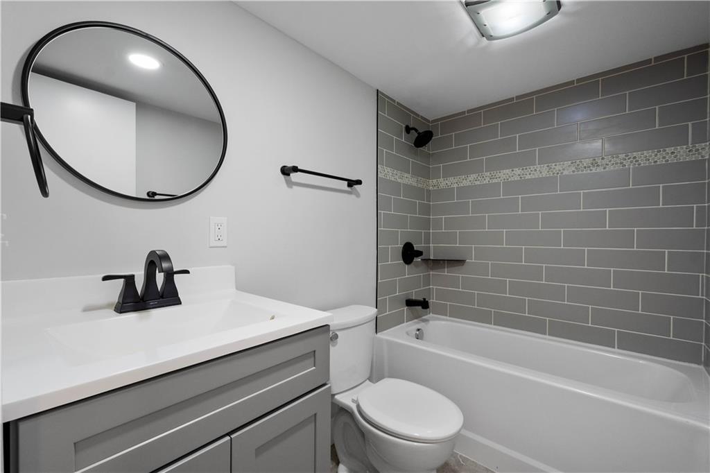 807 McCandless Avenue Pittsburgh, PA 15201 - Photo 18 of 24 a bathroom with a sink a toilet and a mirror