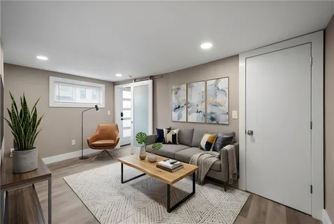 a living room with furniture and a potted plant