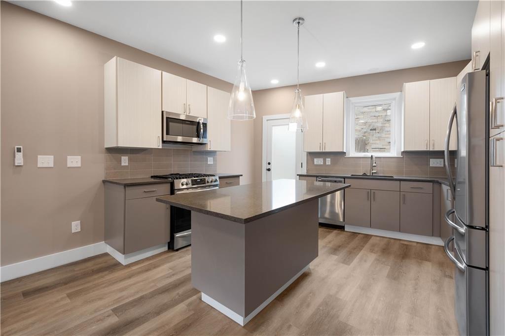 807 McCandless Avenue Pittsburgh, PA 15201 - Photo 3 of 24 a large kitchen with stainless steel appliances granite countertop a stove a sink and a refrigerator