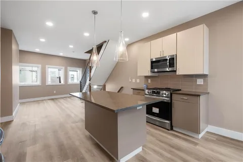 a kitchen with stainless steel appliances granite countertop a stove and a sink