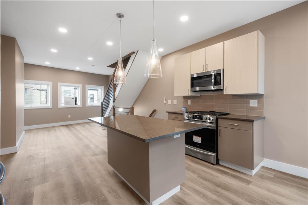 807 McCandless Avenue Pittsburgh, PA 15201 - Photo 6 of 24 a kitchen with stainless steel appliances granite countertop a stove and a sink