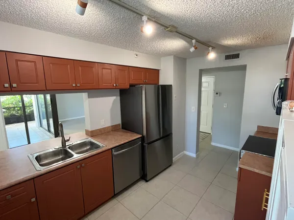 a kitchen with stainless steel appliances a refrigerator and a sink