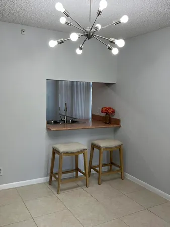 a workspace with furniture and a chandelier fan