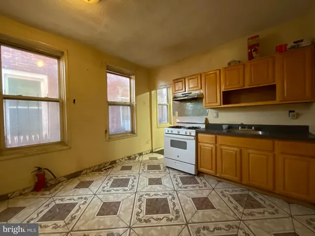 a kitchen with stainless steel appliances granite countertop a sink and cabinets