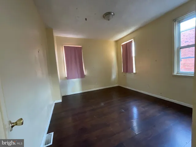 a bathroom with a granite countertop toilet and a sink