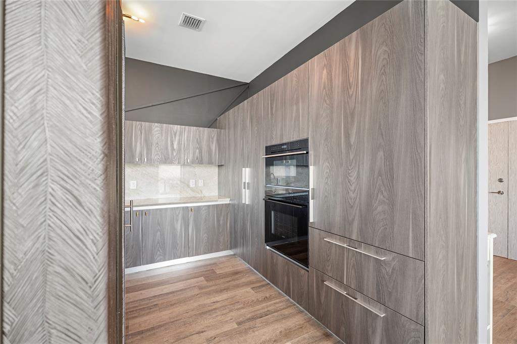 480 Northeast 31st Street, Unit 5104A Miami, FL 33137 - Photo 14 of 26 a kitchen with a refrigerator and white wall
