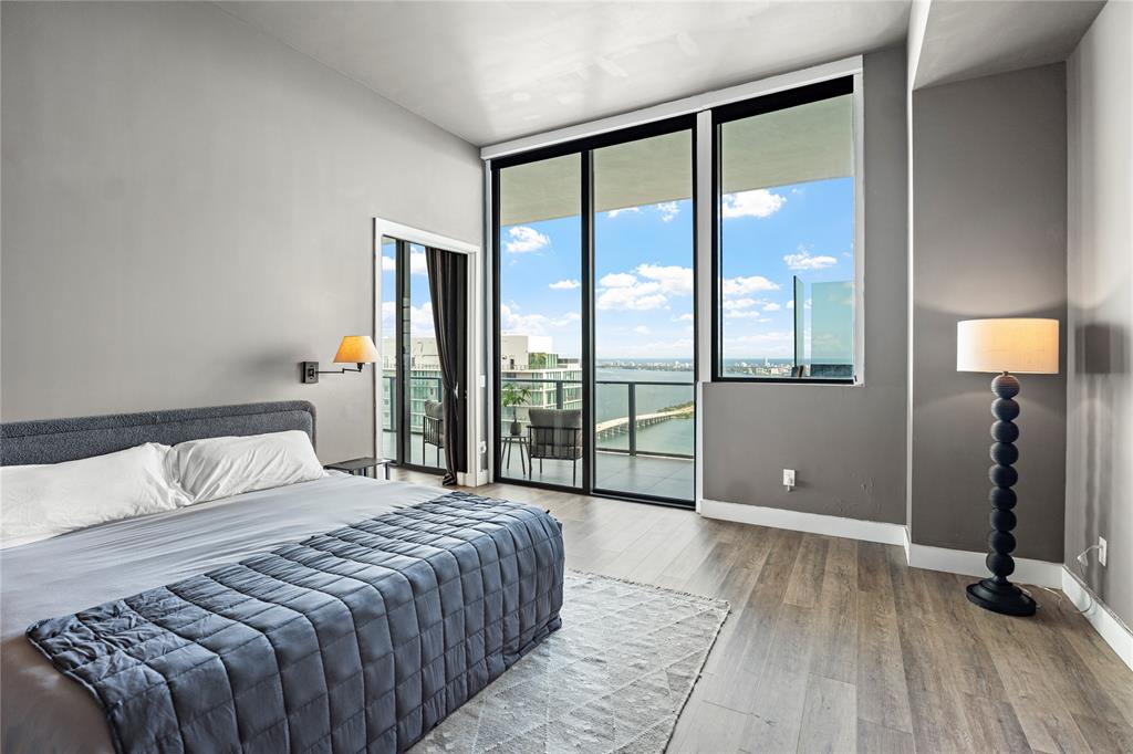480 Northeast 31st Street, Unit 5104A Miami, FL 33137 - Photo 15 of 26 a bedroom with a large bed and a large window