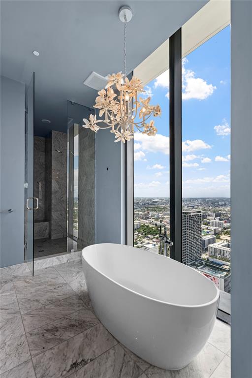 480 Northeast 31st Street, Unit 5104A Miami, FL 33137 - Photo 21 of 26 a white bath tub sitting in a bathroom next to a large window