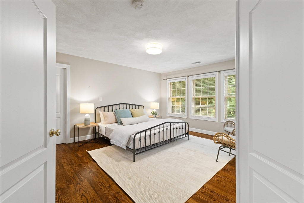 58 Mansfield Road Lynnfield, MA 01940 - Photo 17 of 42 a spacious bedroom with a bed and a window
