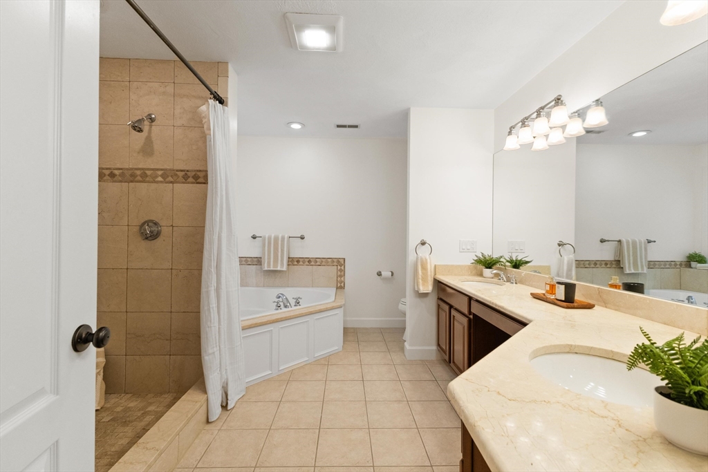 58 Mansfield Road Lynnfield, MA 01940 - Photo 22 of 42 a large white kitchen with a stove a sink dishwasher and a refrigerator with wooden floor
