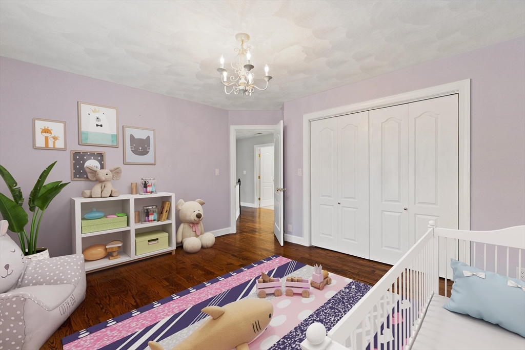 58 Mansfield Road Lynnfield, MA 01940 - Photo 25 of 42 a bedroom with a bed and a chandelier